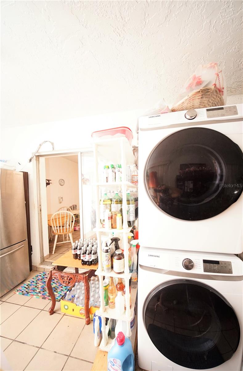 Washer and dryer stackable in Florida room.