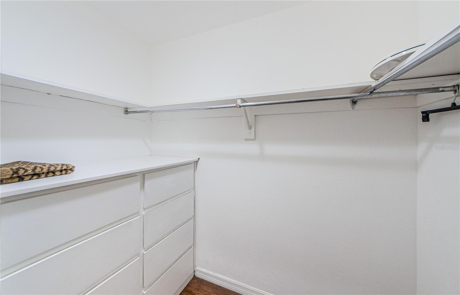 Walk-in Closet to Master Bedroom with built in dresser and lots of drawers.