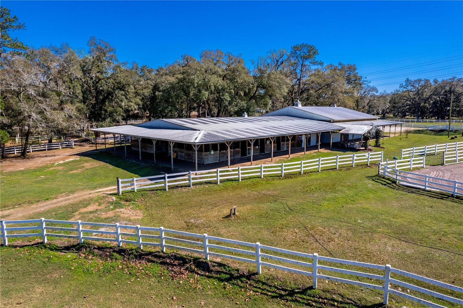 26 Stall Center Aisle Barn with Bathroom/Tack Room/ Feed Room/Covered Arena