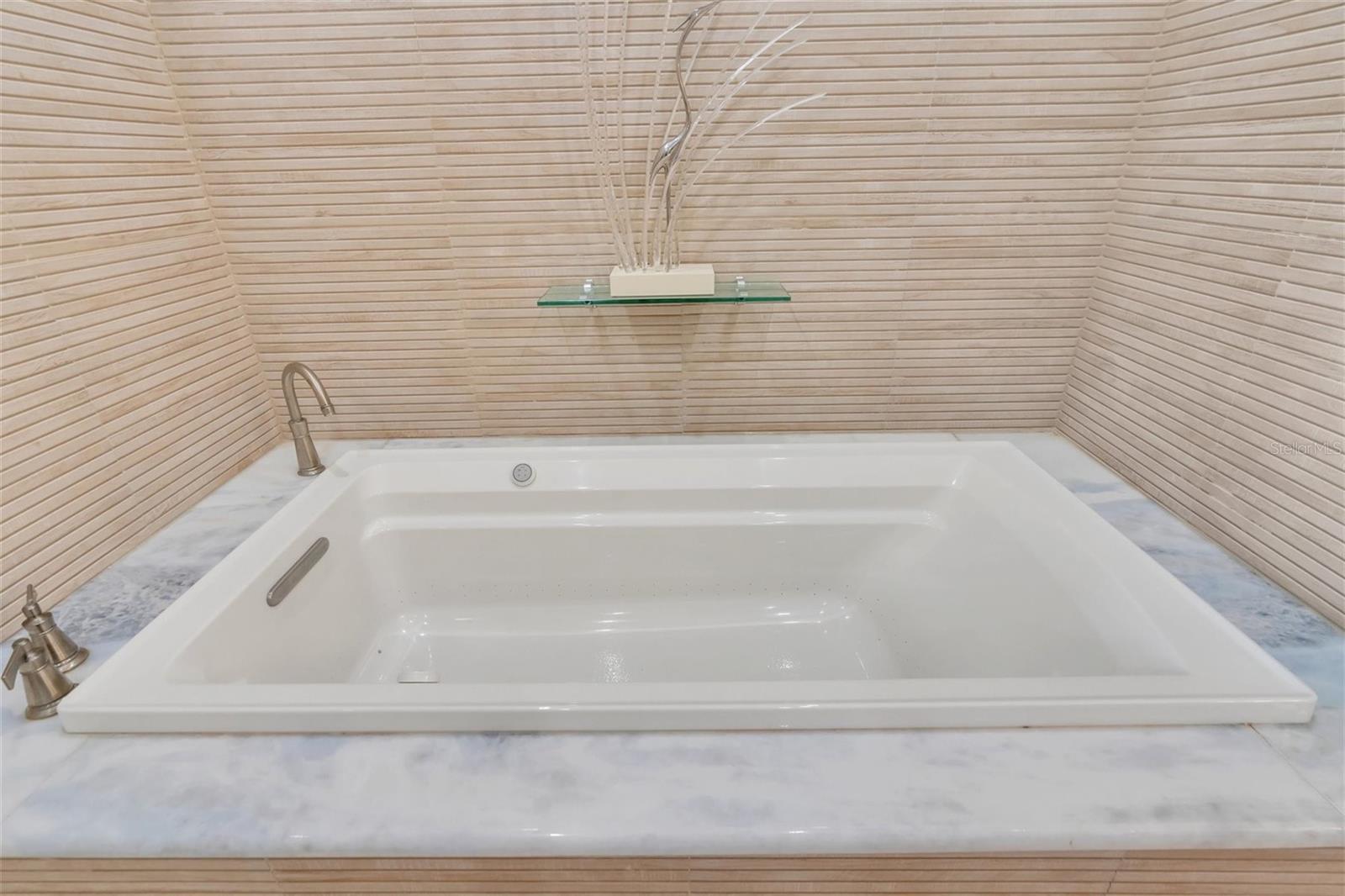 7 foot Air Jacuzzi soaking tub with marble deck
