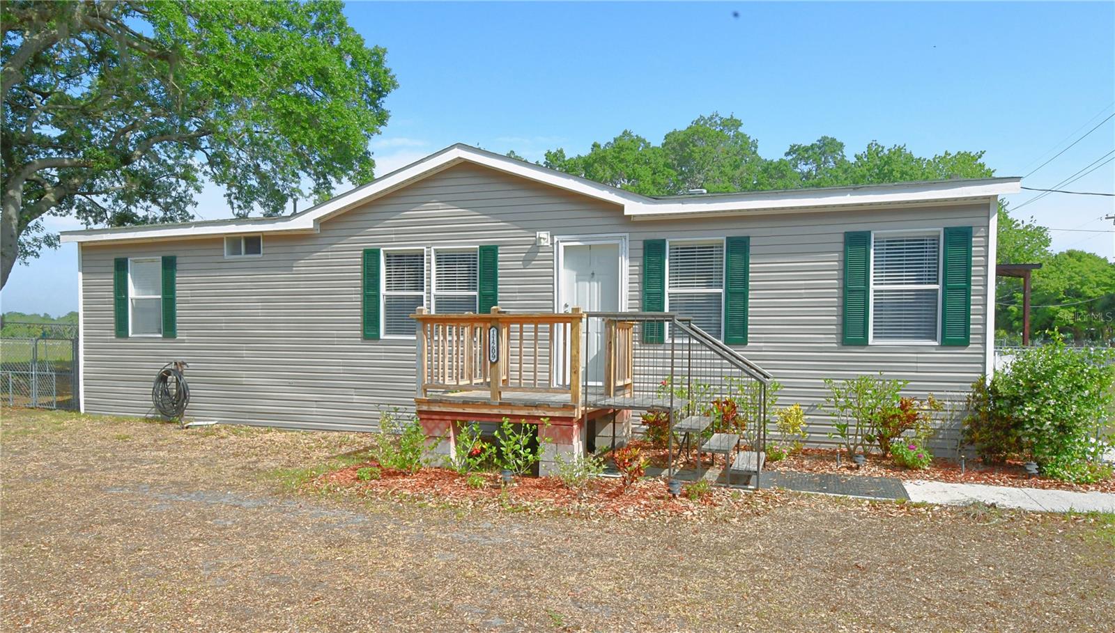 Charming 3-bedroom, 2-bath, double-wide manufactured home nestled in a picturesque, park-like setting.