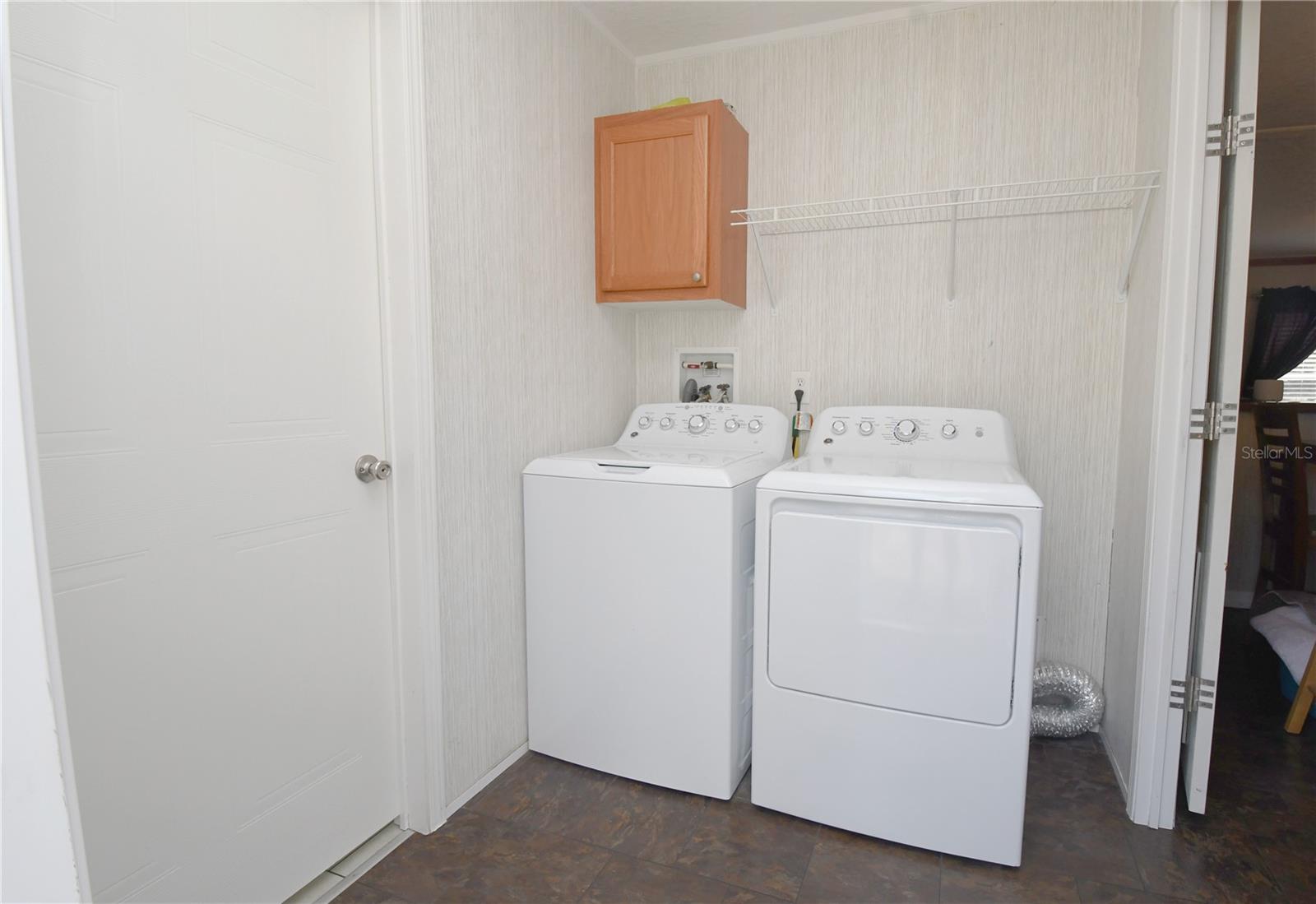 The laundry room features  new GE washer and dryer.