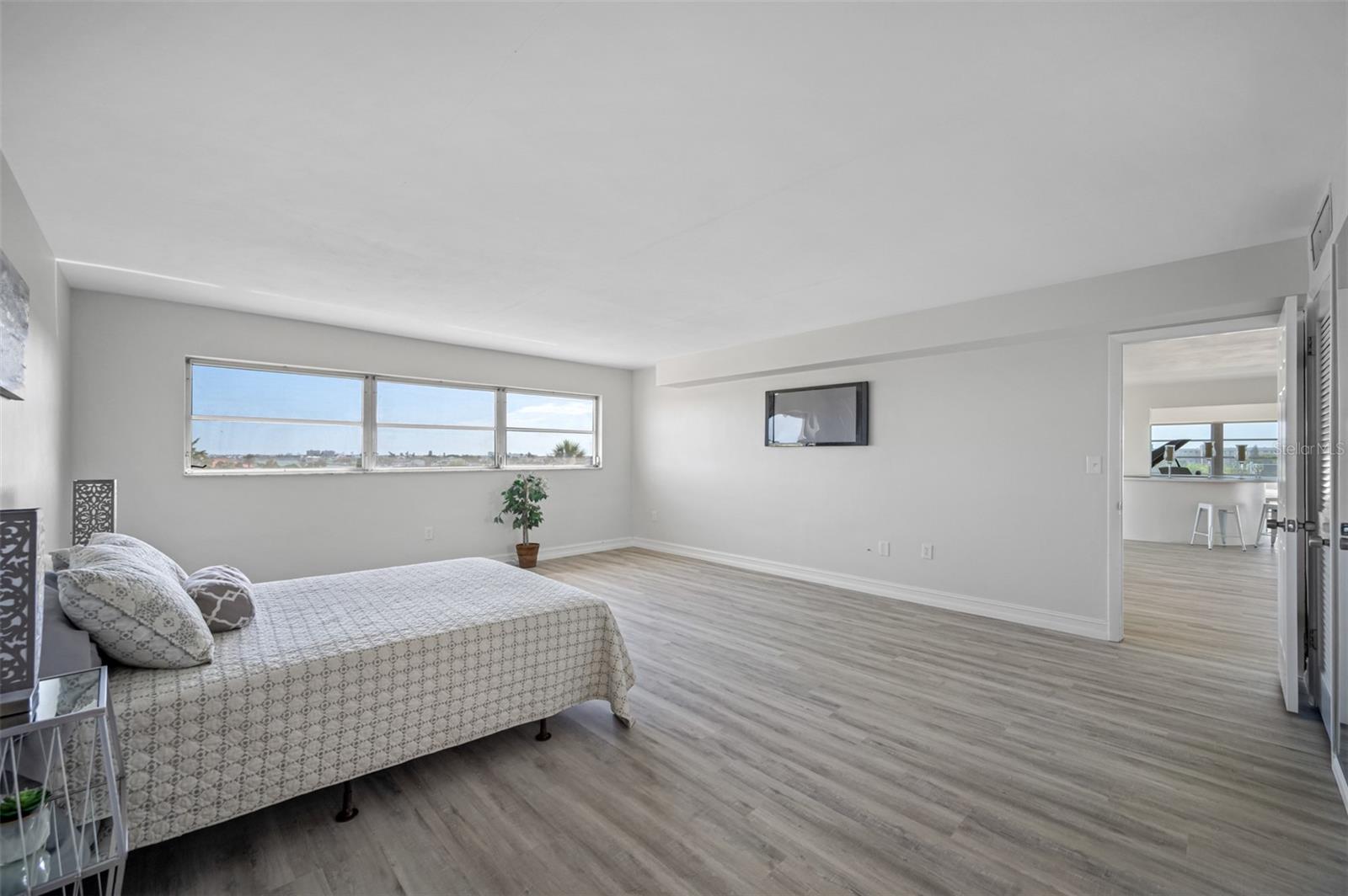 Primary bedroom with views of intracoastal waterway and community pool.