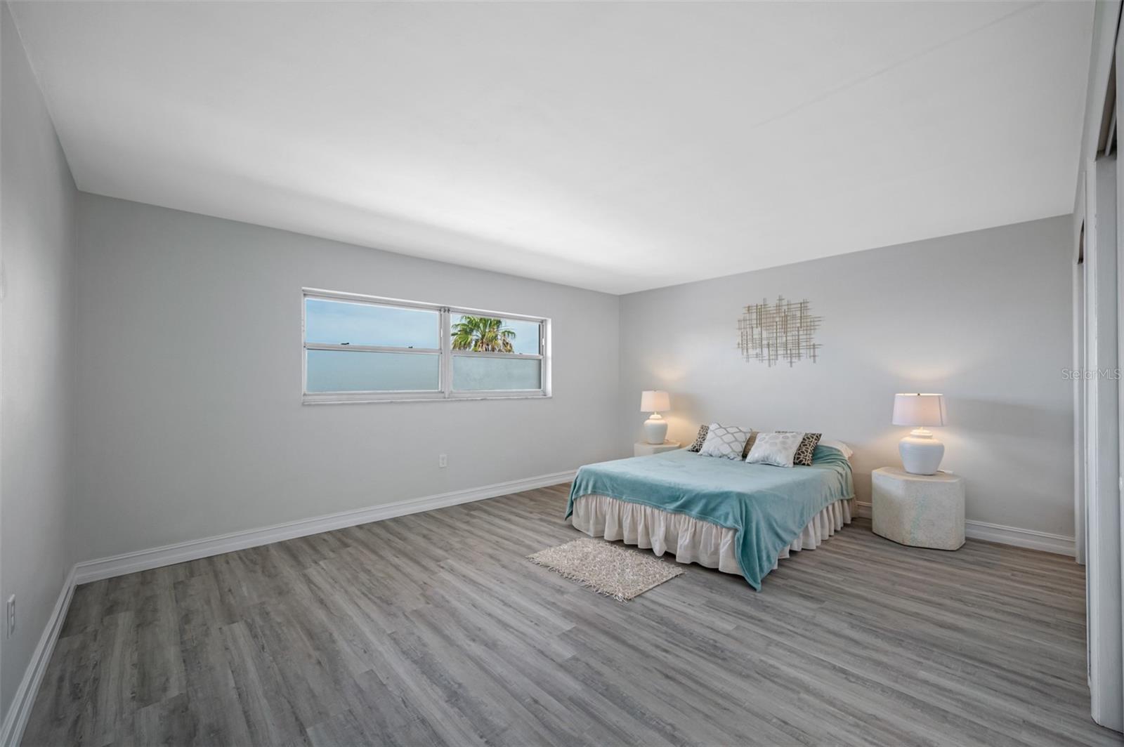 Oversized guest bedroom with partial gulf view.