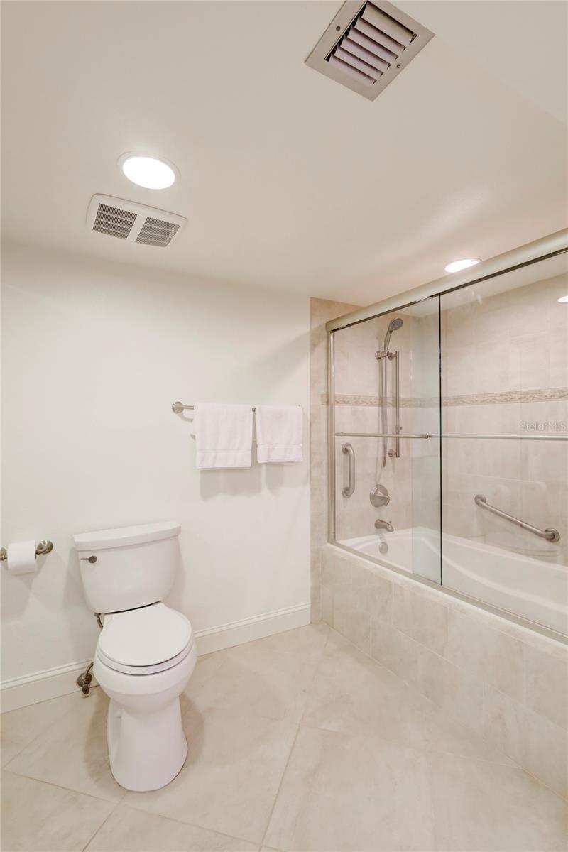 Main bath has a tub/shower combo with glass doors