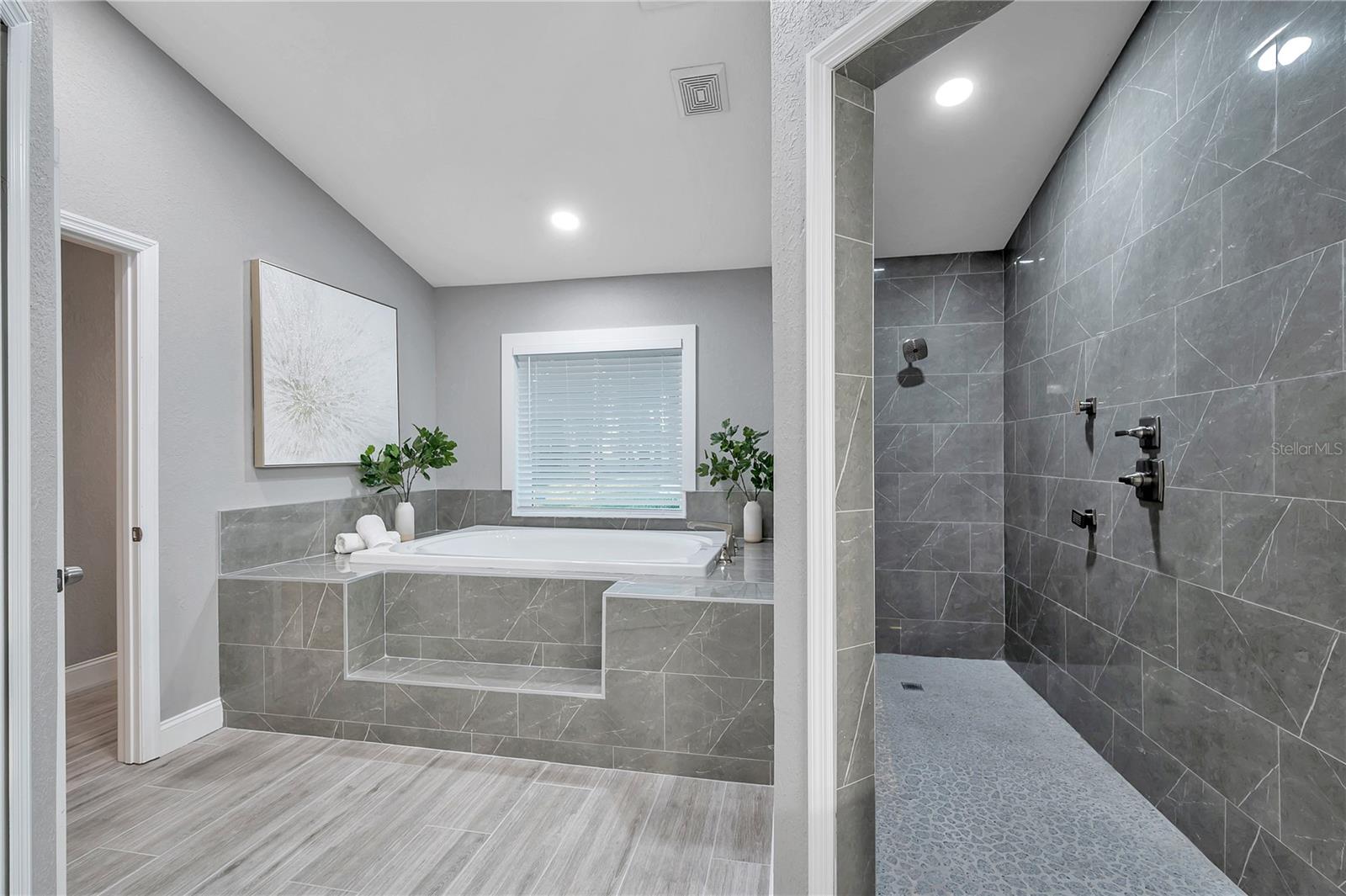 Garden tub & floor-to-ceiling tiled shower.