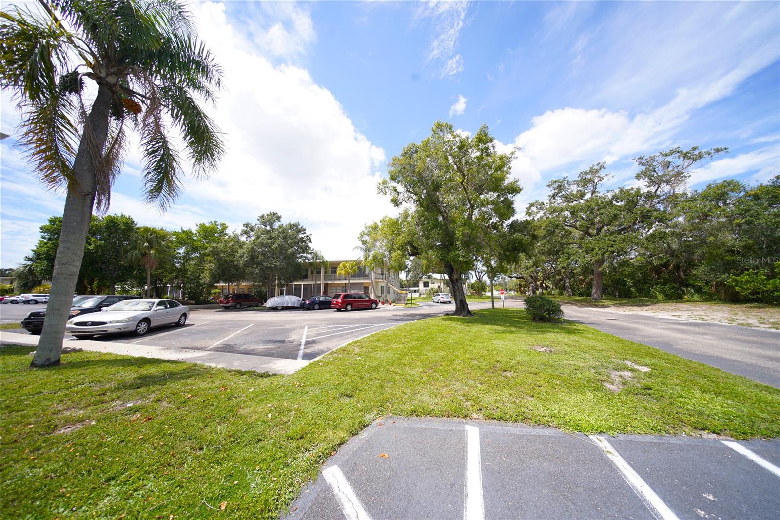 2-bedroom condo in PET FRIENDLY complex with assigned Parking lot visible to the right.
