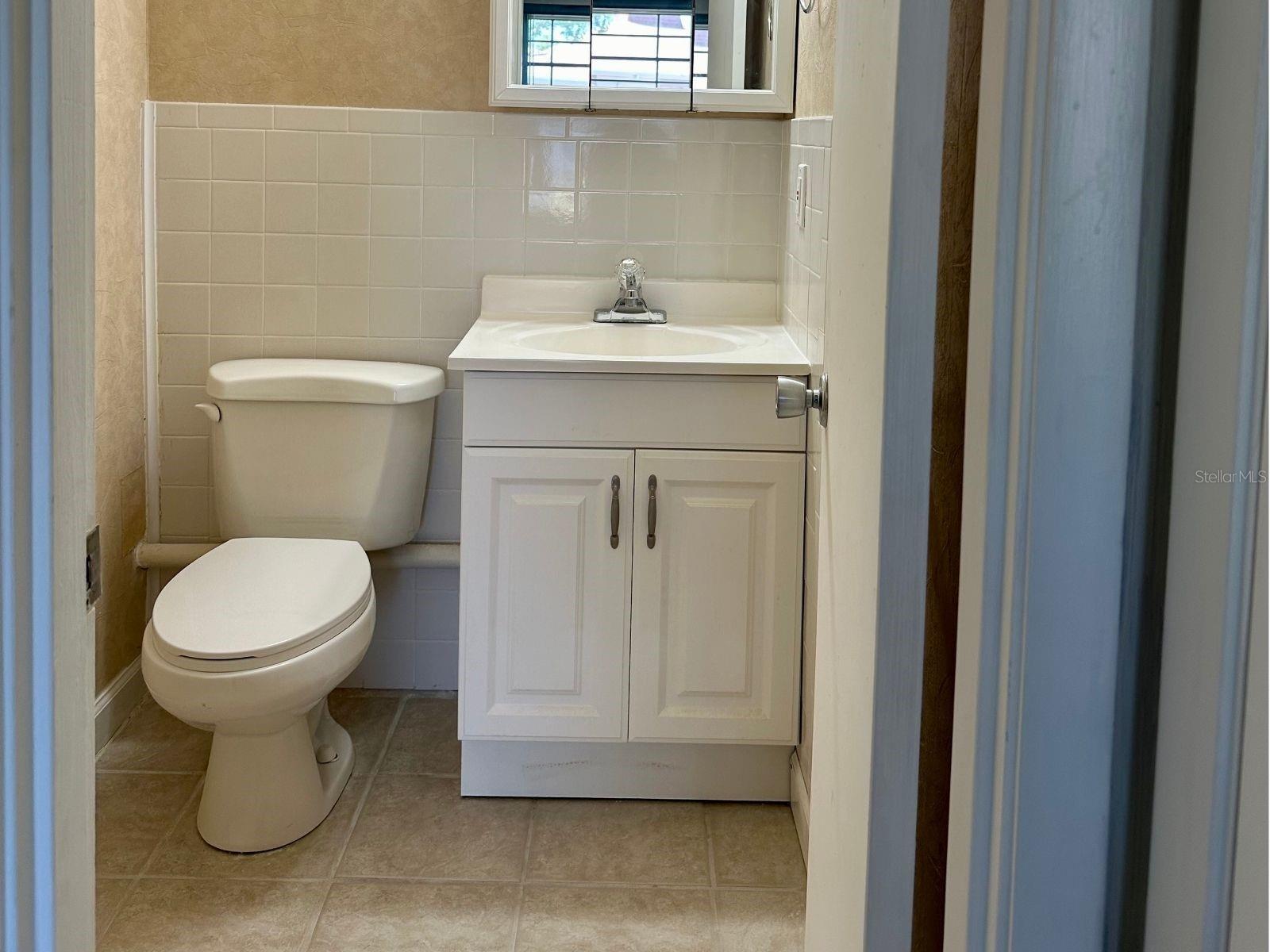 Effortless elegance awaits! Discover a half bath conveniently nestled within the primary bedroom for added comfort and privacy.