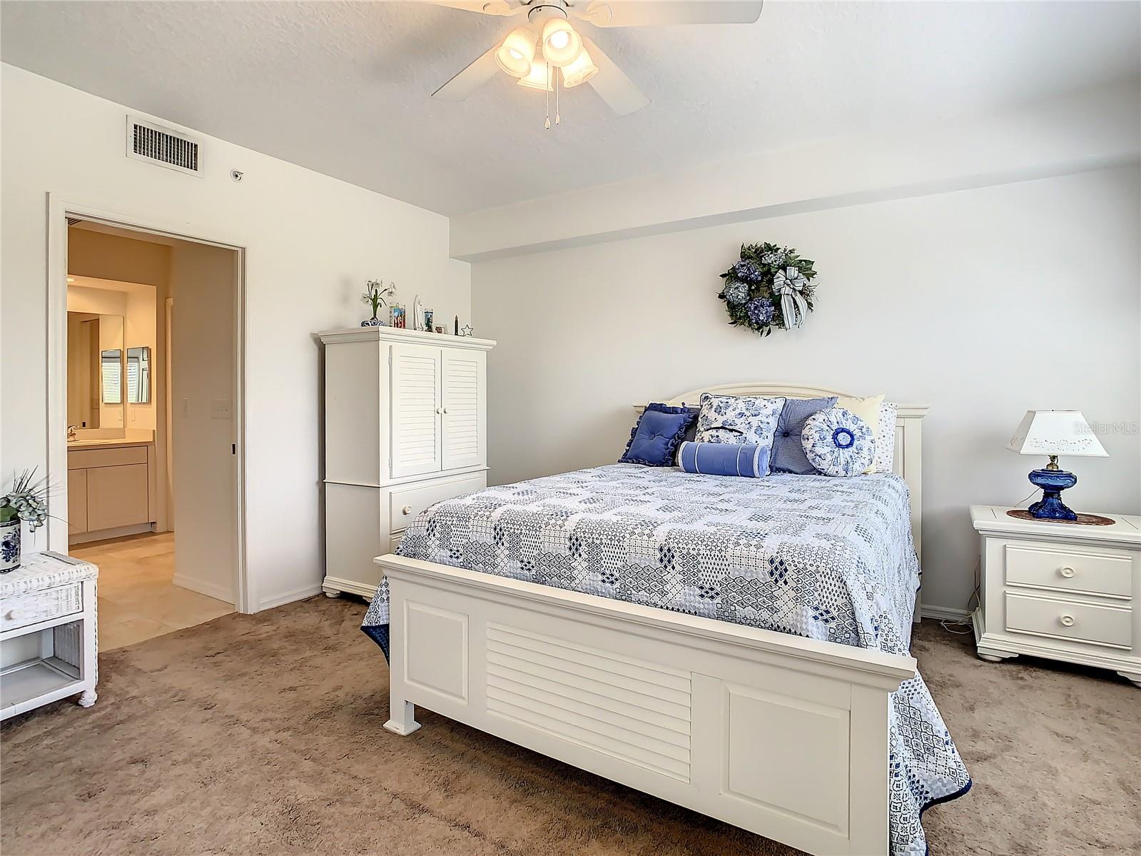 The master bedroom boasts private access to the balcony, an ensuite bath with his and her walk-in closets, a dual sink vanity, and stand-up shower