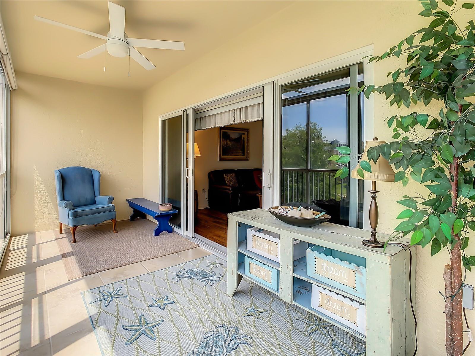 Nice-sized balcony with its upgraded screen & glass enclosure featuring enhanced blinds which can provide shade from the heat and sun without completely blocking the views or be opened to fully enjoy the picturesque golf course and pond with captivating fountain