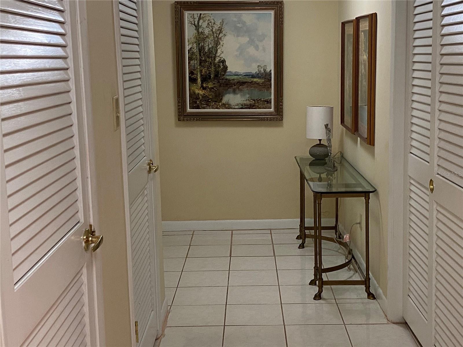 Front Entrance is across from the side table.  Entrance Hall with double wide coat closet, walk-in pantry and mechanical closet.