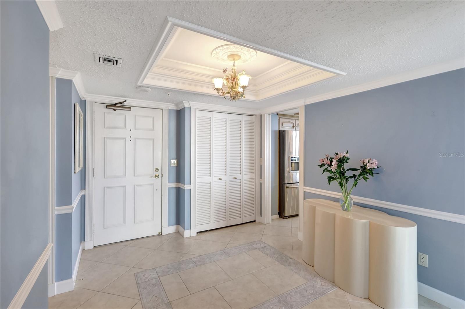 Entry Foyer with Guest Closet, custom coffered ceiling & chair rail.