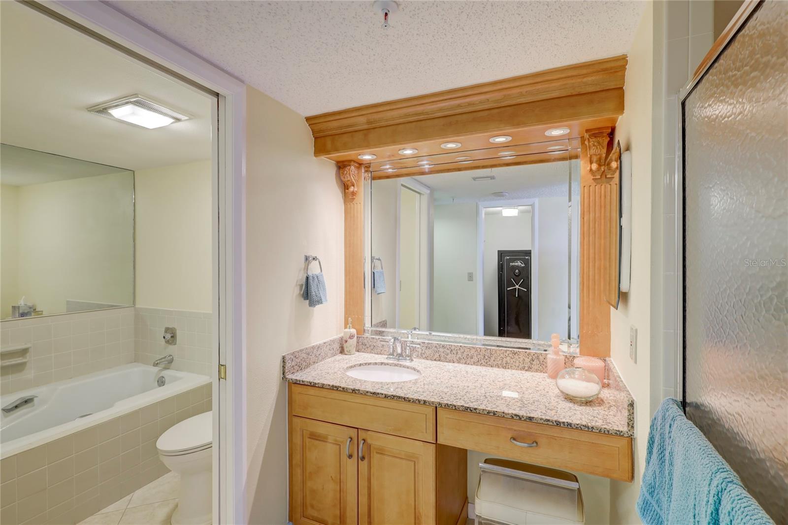 Master private tub & remodeled  designer vaniety wood cabinetry + granite counter.