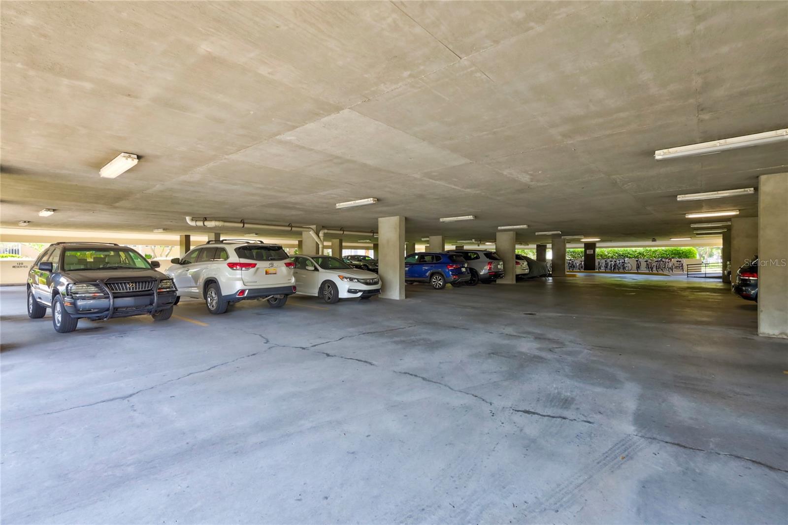 One story Garage with bike racks, open walk way exclusive for buildings A ad B to Clubhouses, private pool and spa. Also from garage, closet with grocery carts, covered, wide walk way to keyed lobby.
