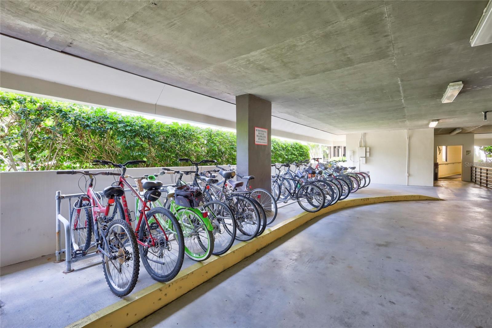 Garage bike rack + open entrance walk on left to private pool, also grocery cart storage closet, and covered wide walk way to keyed Lobby & 2 elevators.