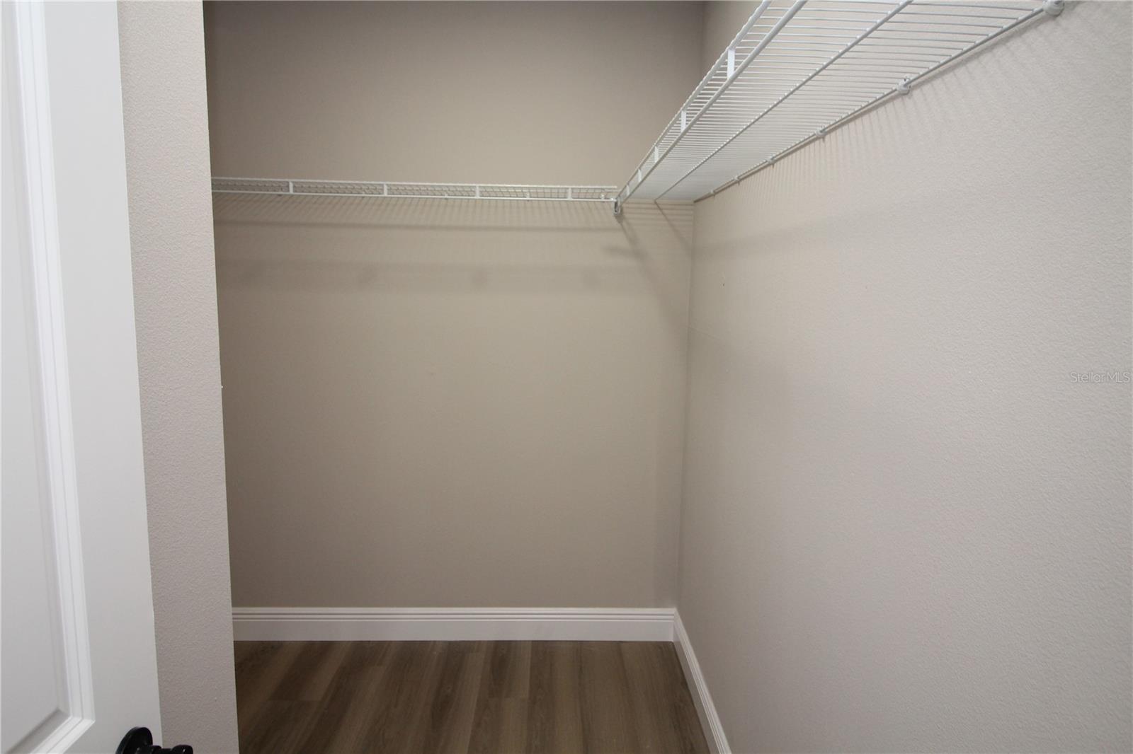 Large master bedroom walk-in closet with new wire closet shelving