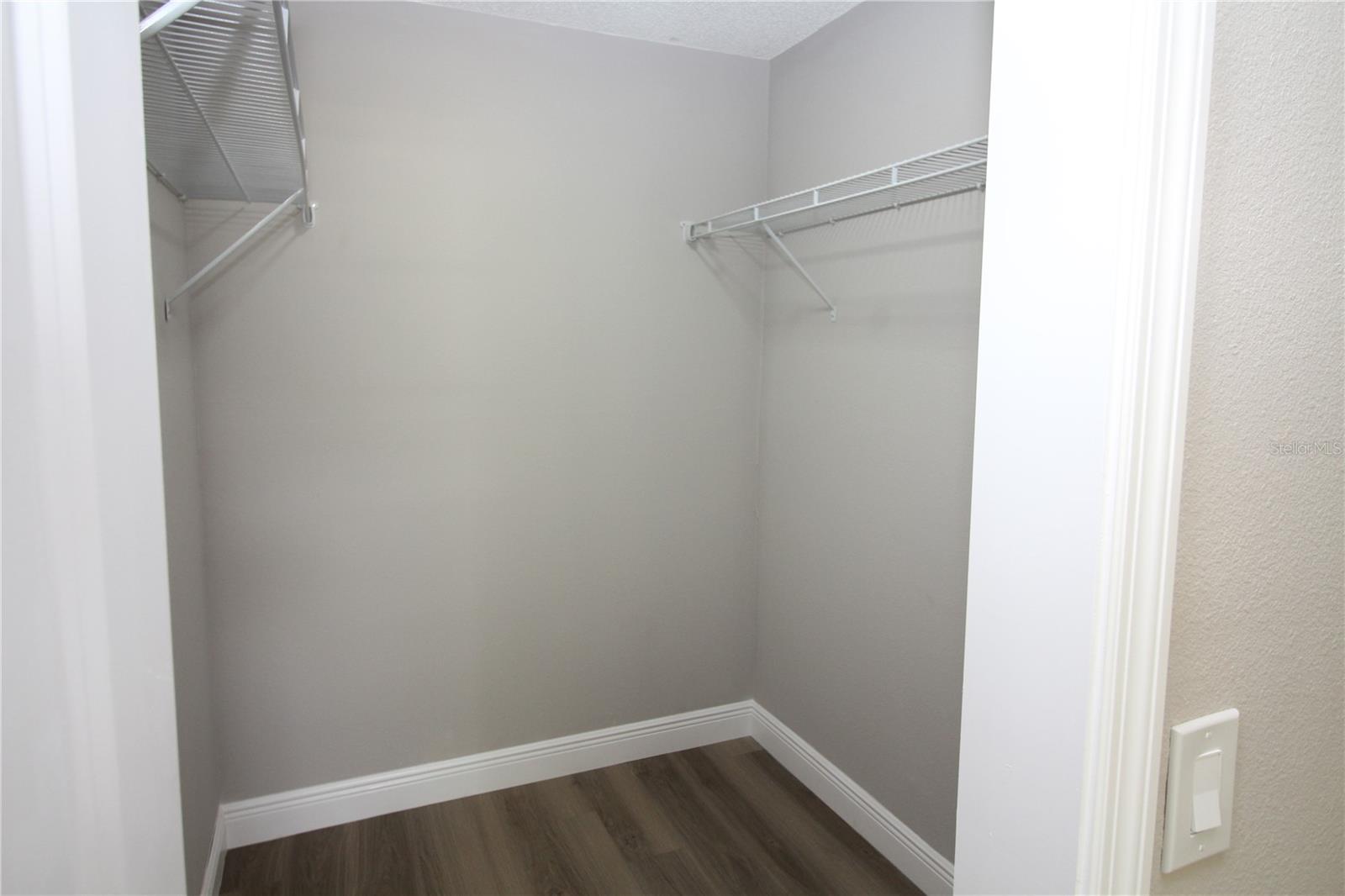 Master bedroom walk-in closet with new wire closet organizers