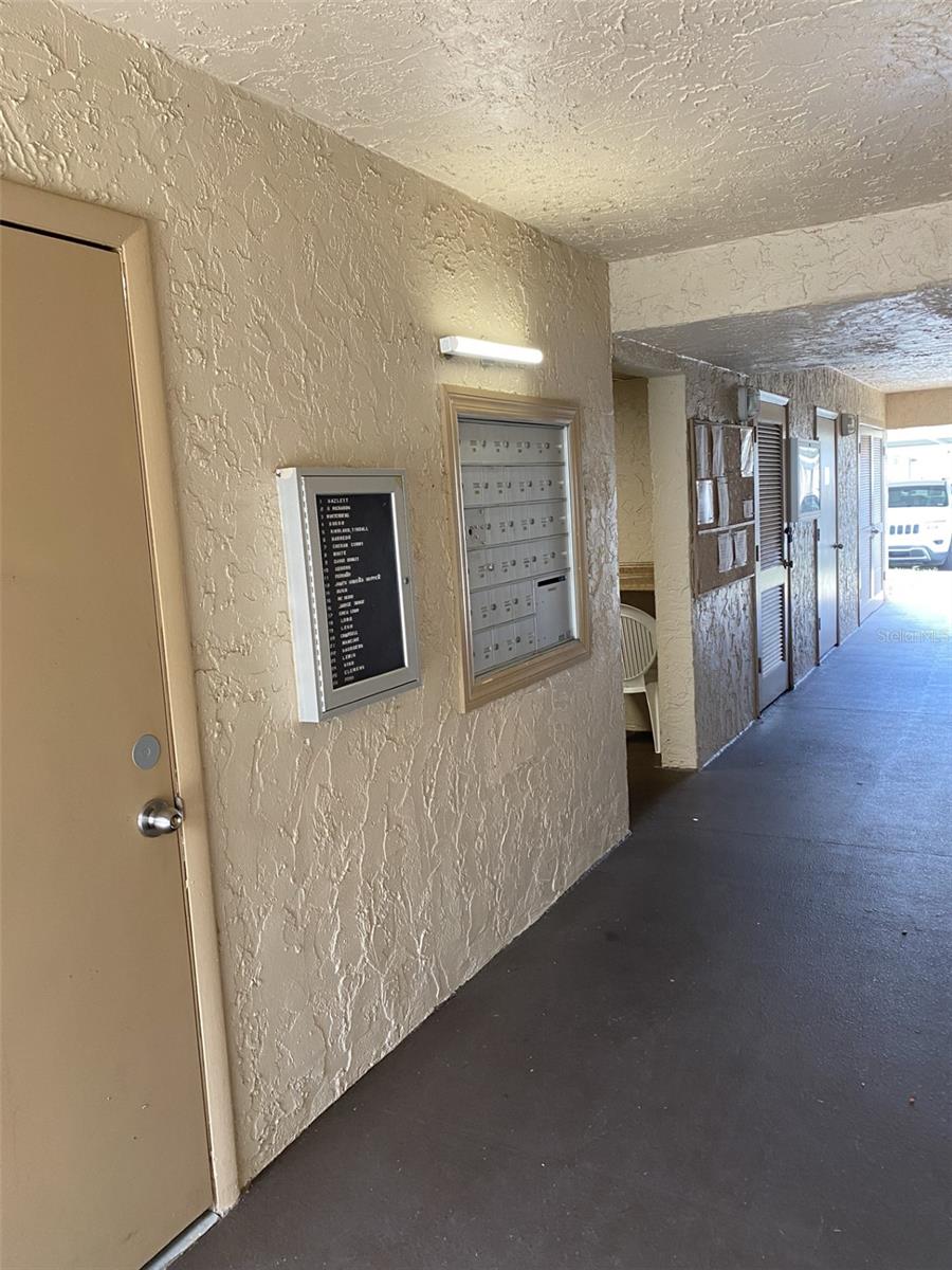 Hallway Leading To Laundry Room, Mailboxes and Small Building 2 Community Shared Closet-Size Storage Room