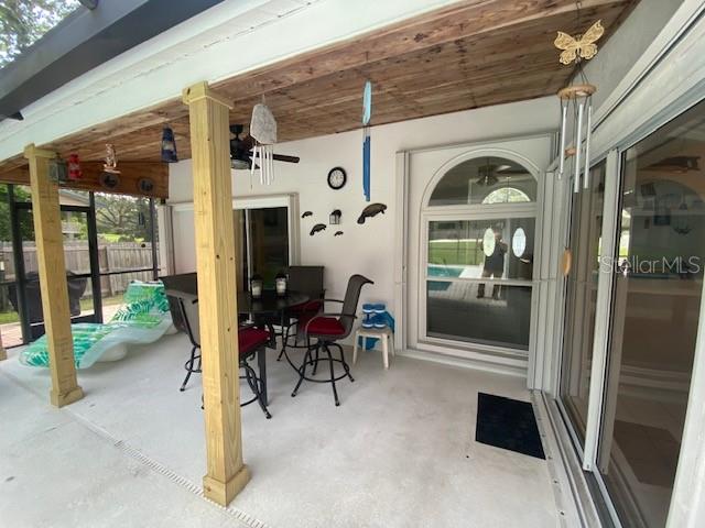 Pool patio porch with wood plank ceiling.