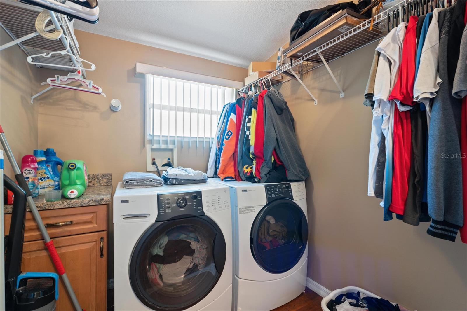 Large inside laundry with ample storage.