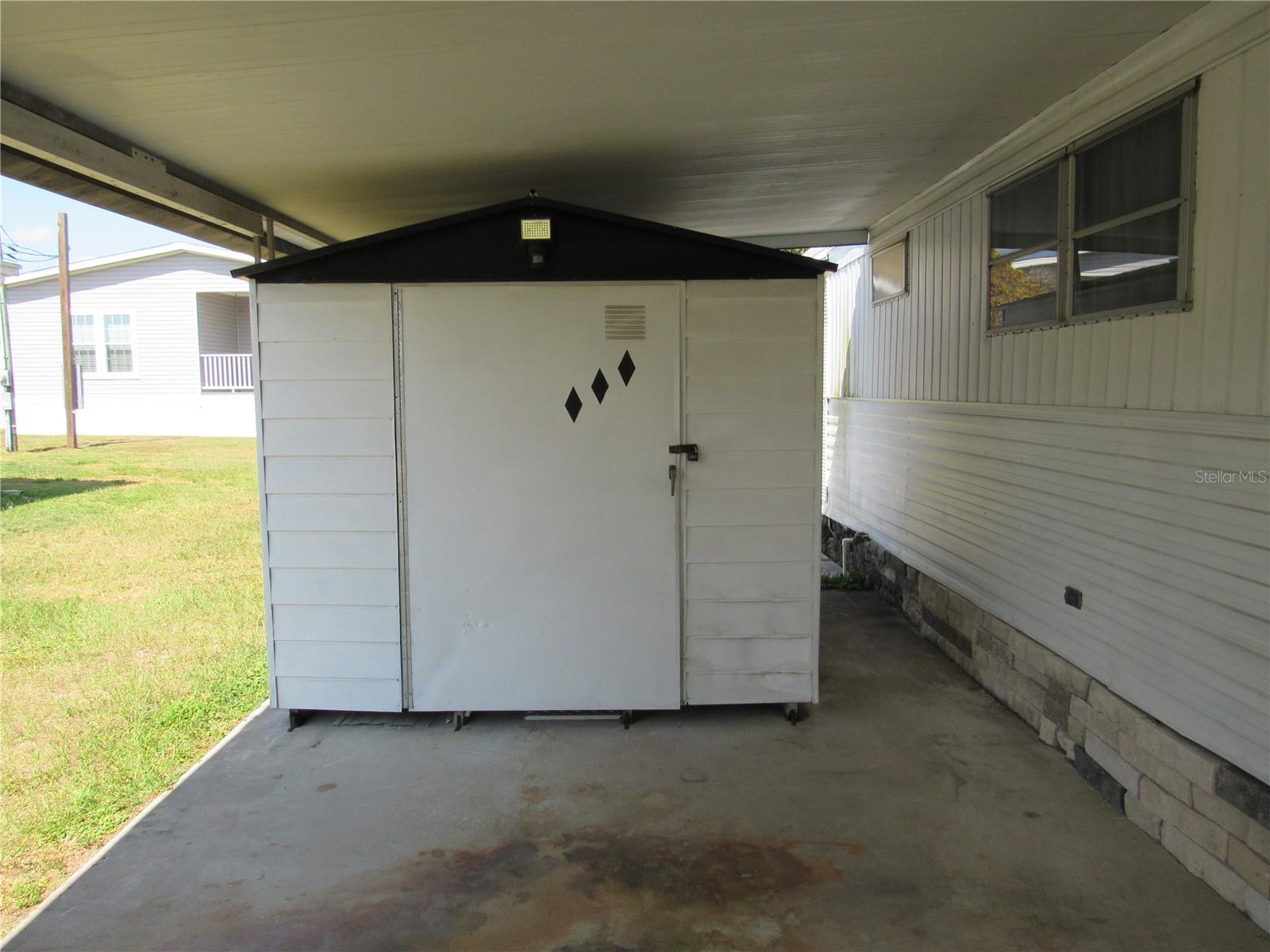 Laundry shed with washer/dryer/laundry tub.
