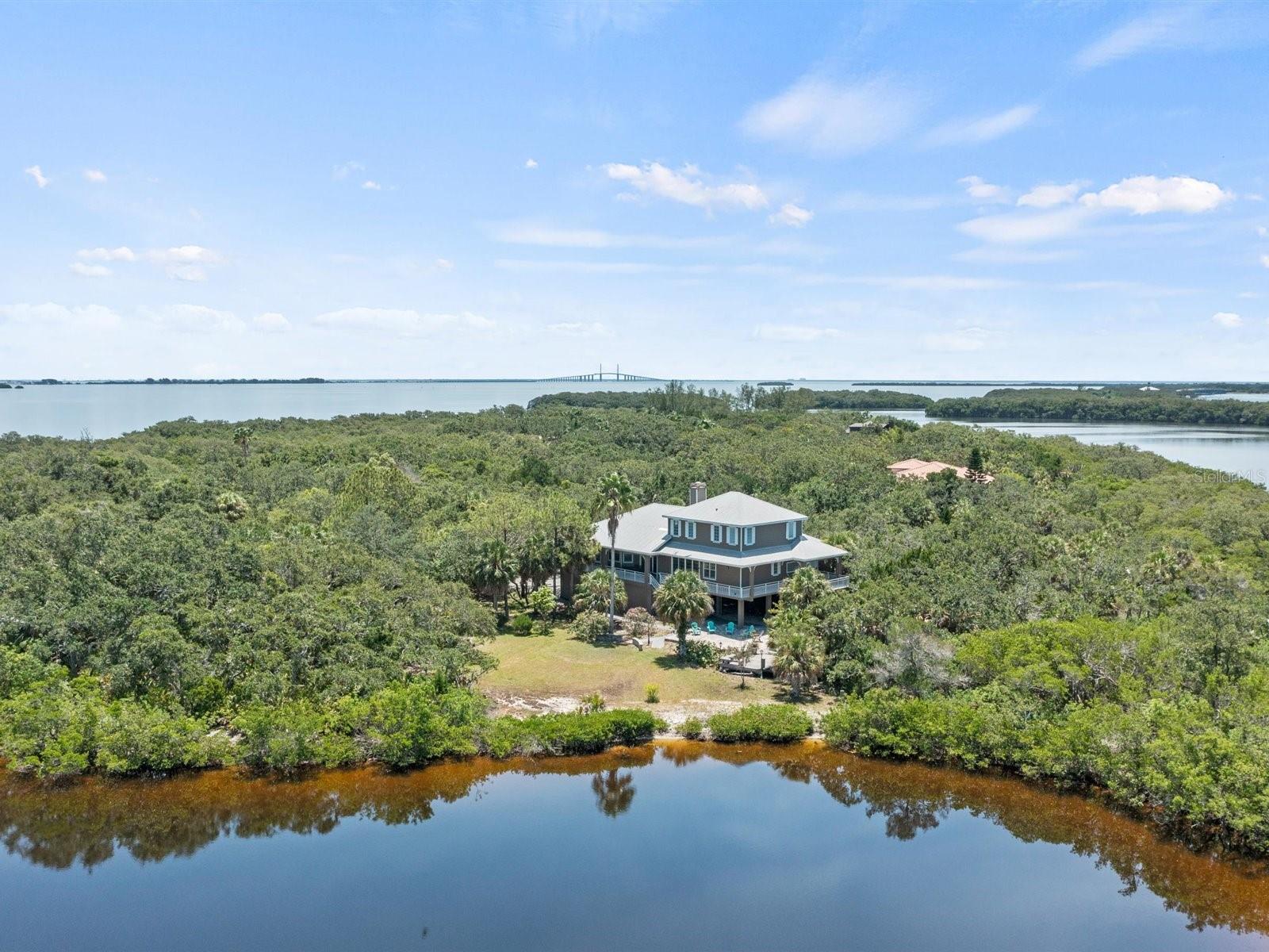 Aerial of home with Skyway Bridge in the distance.