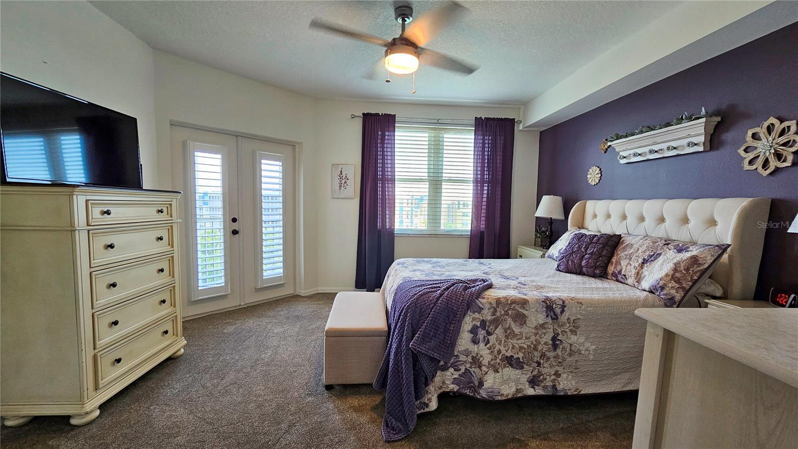 Master Bedroom w/french doors adorned with plantation shutters that open onto your private lanai.