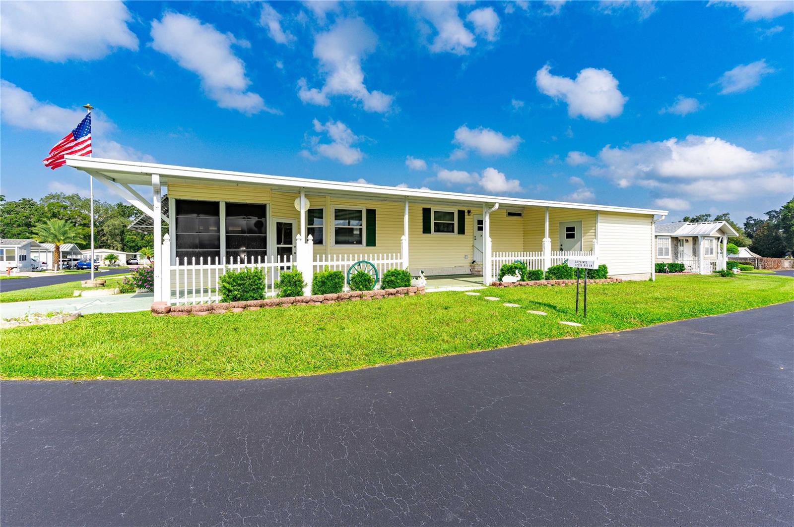 This corner lot home is across the road from club house, pool, and indoor shuffle.