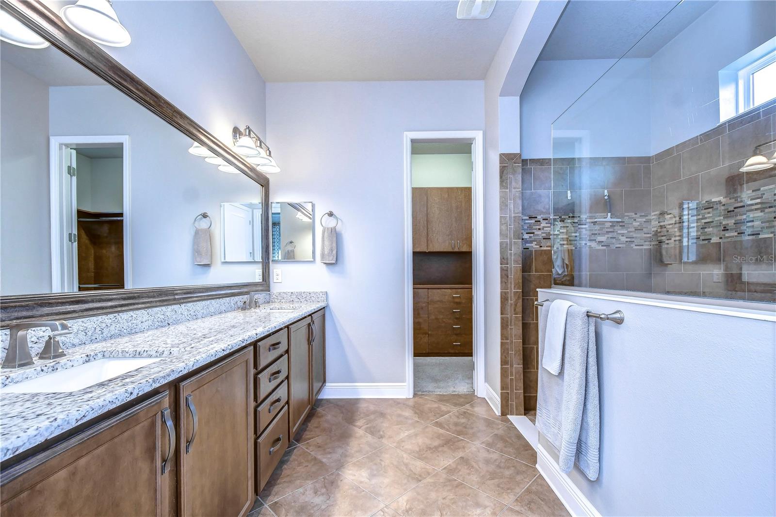 Opulent en-suite bathroom boasts dual sinks!