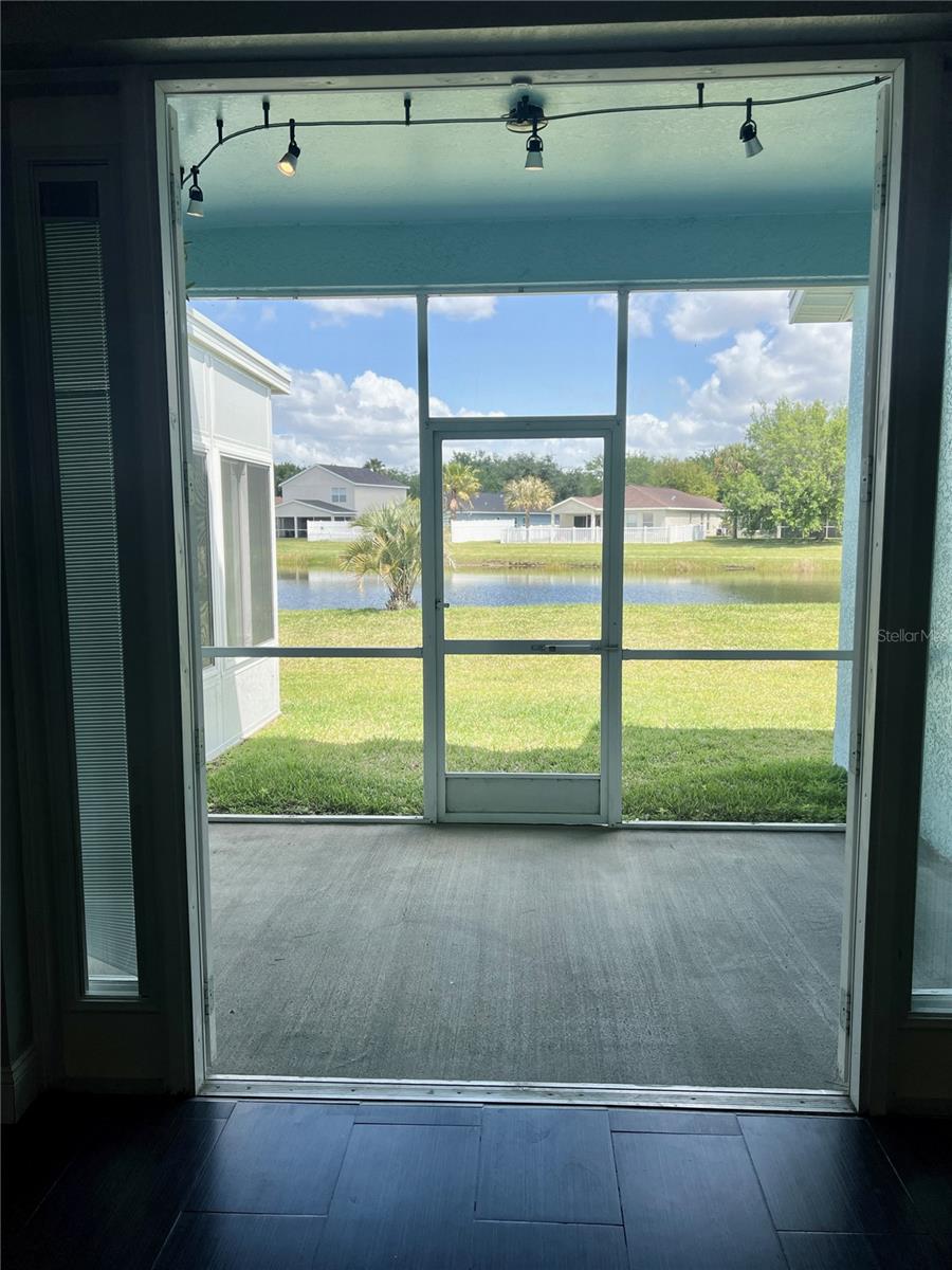 View of double French doors into the lanai and exterior view of pond #1