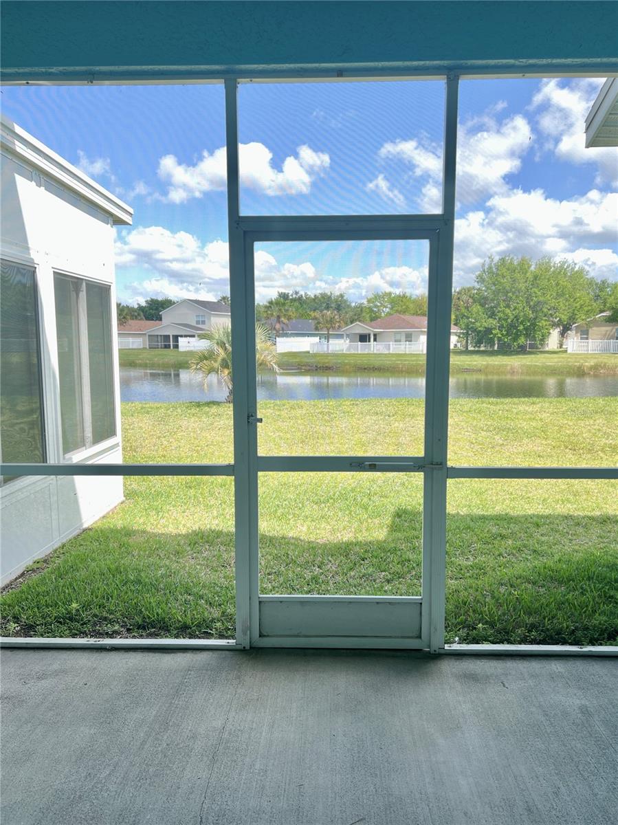 View of double French doors into the lanai and exterior view of pond #2