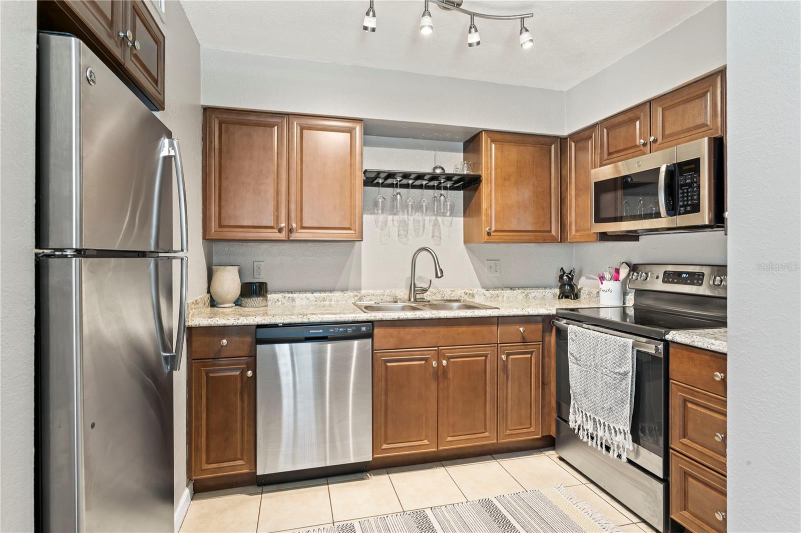 Kitchen with granite counter tops and stainless steel appliances.