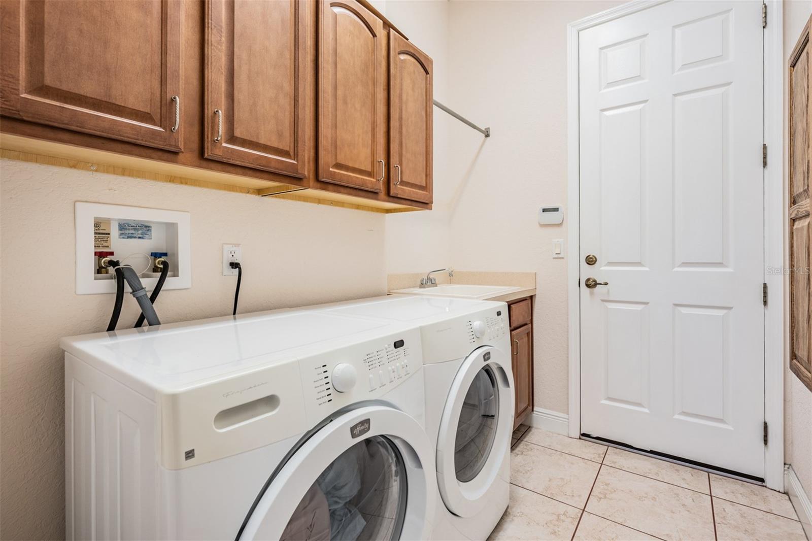 Custom built in ironing board in this functional laundry room!