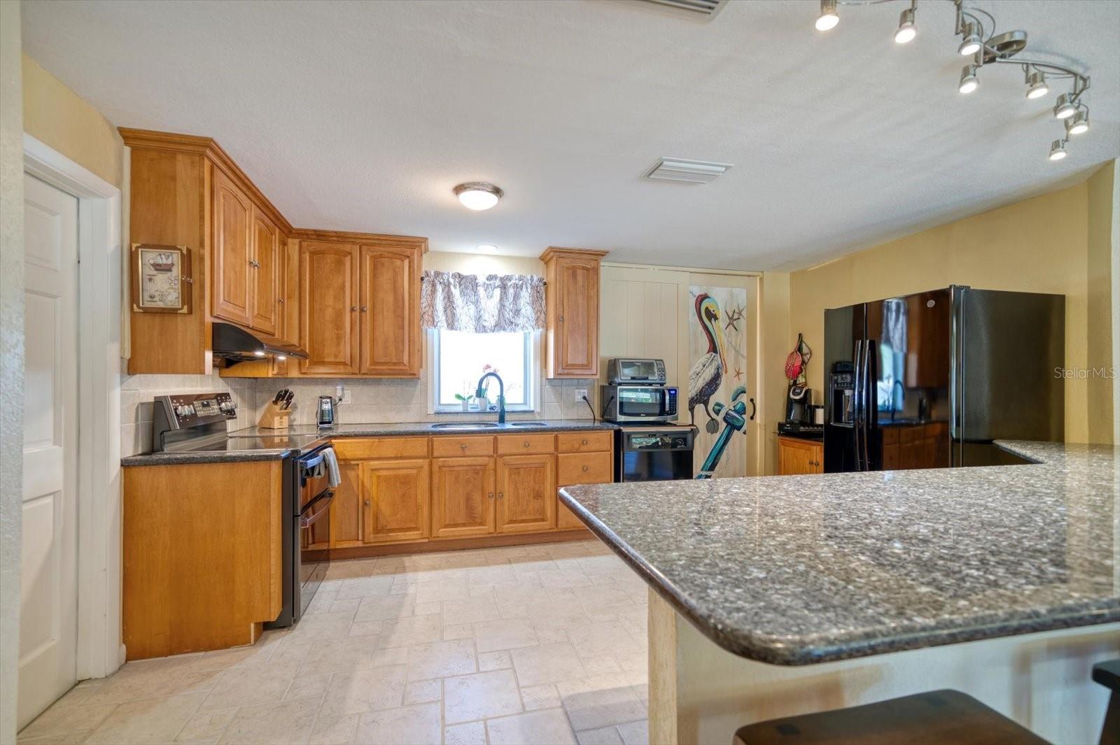 Spacious in size the kitchen has a nice flow with newer appliances and large pantry.