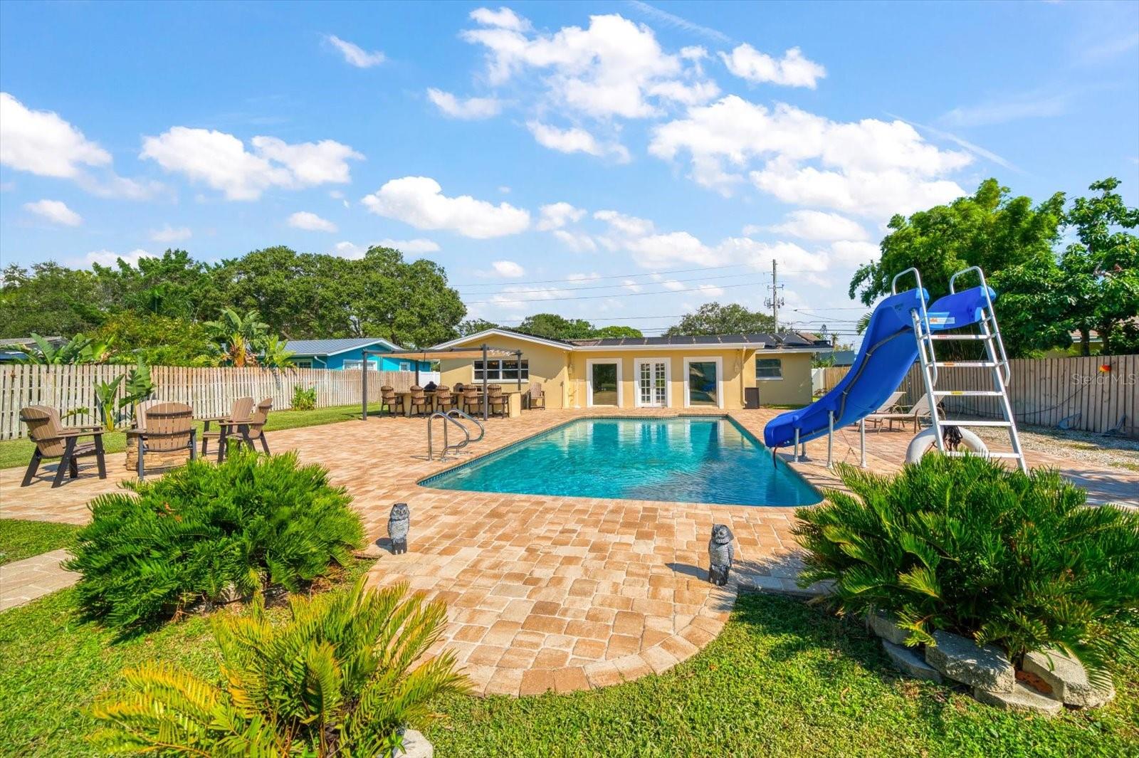 Lushly landscaped yard! Fun for everyone in the pool or at the outdoor gathering areas.