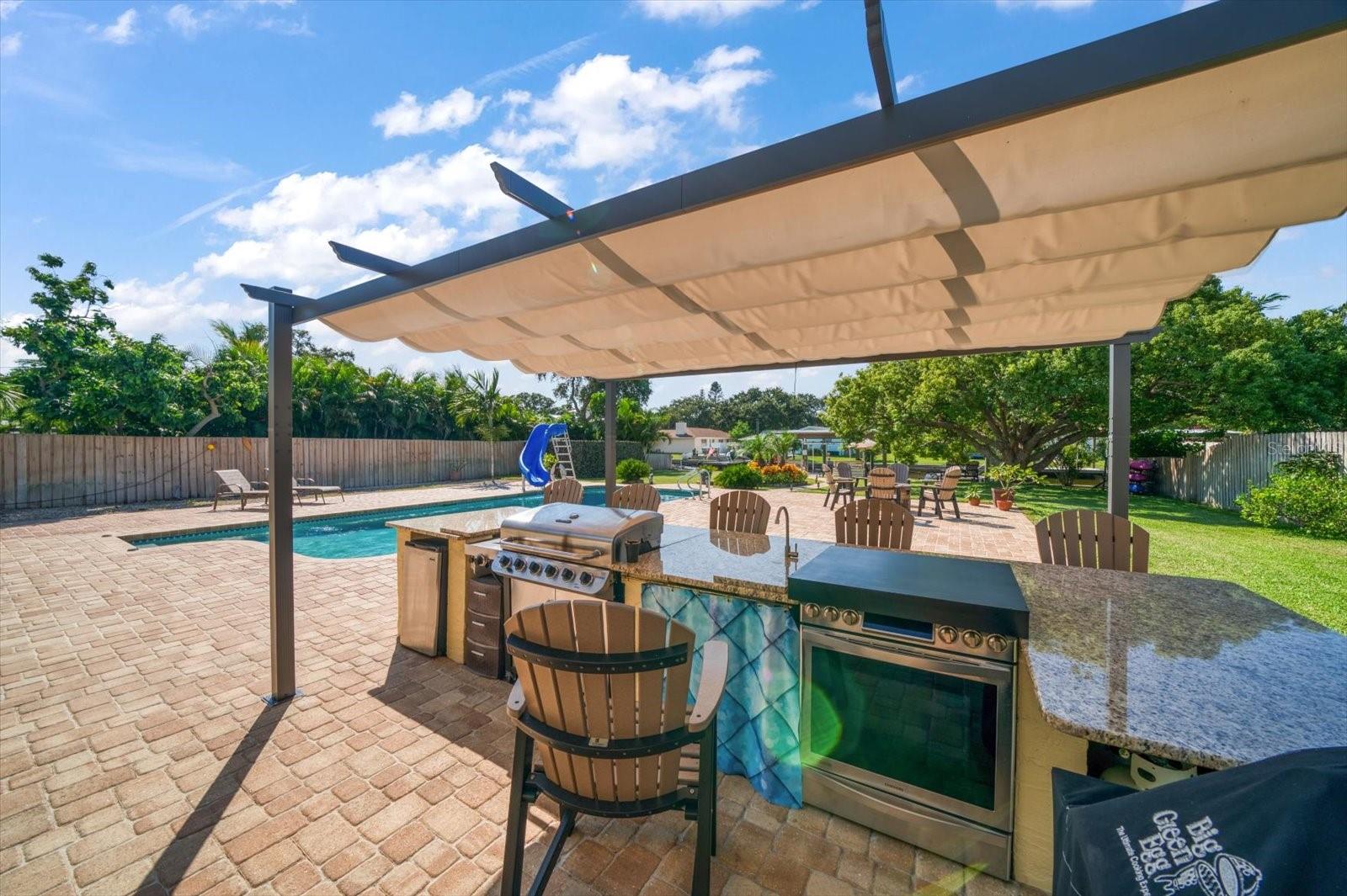 Outdoor kitchen area is perfect for Sunday bar-b-ques or enjoy cooling off in the sparkling pool, or cruising coastal waters in your boat moored at your dock.