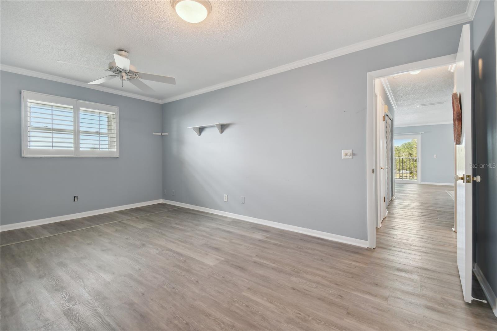 Primary bedroom with plantation shutters on the windows to keep it light and bright.