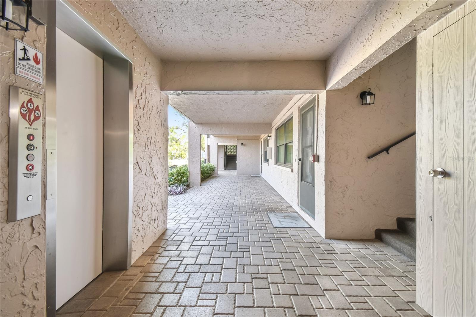 This is the downstairs area with stairs and storage rooms for beach chairs or bikes.