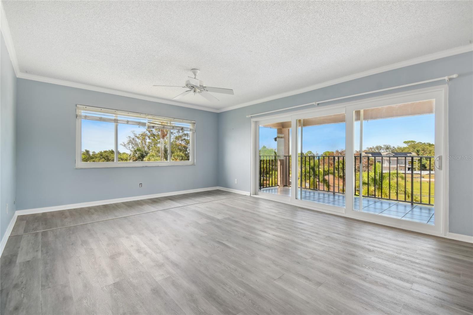 The living room leading to the balcony with hurricane sliders is where you will most likely spend most of your time enjoying the view.