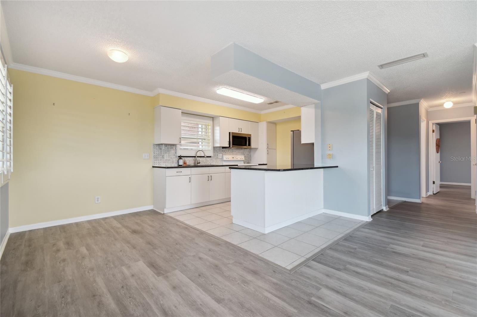 Nice open kitchen and dining area with eat in area at the bar.