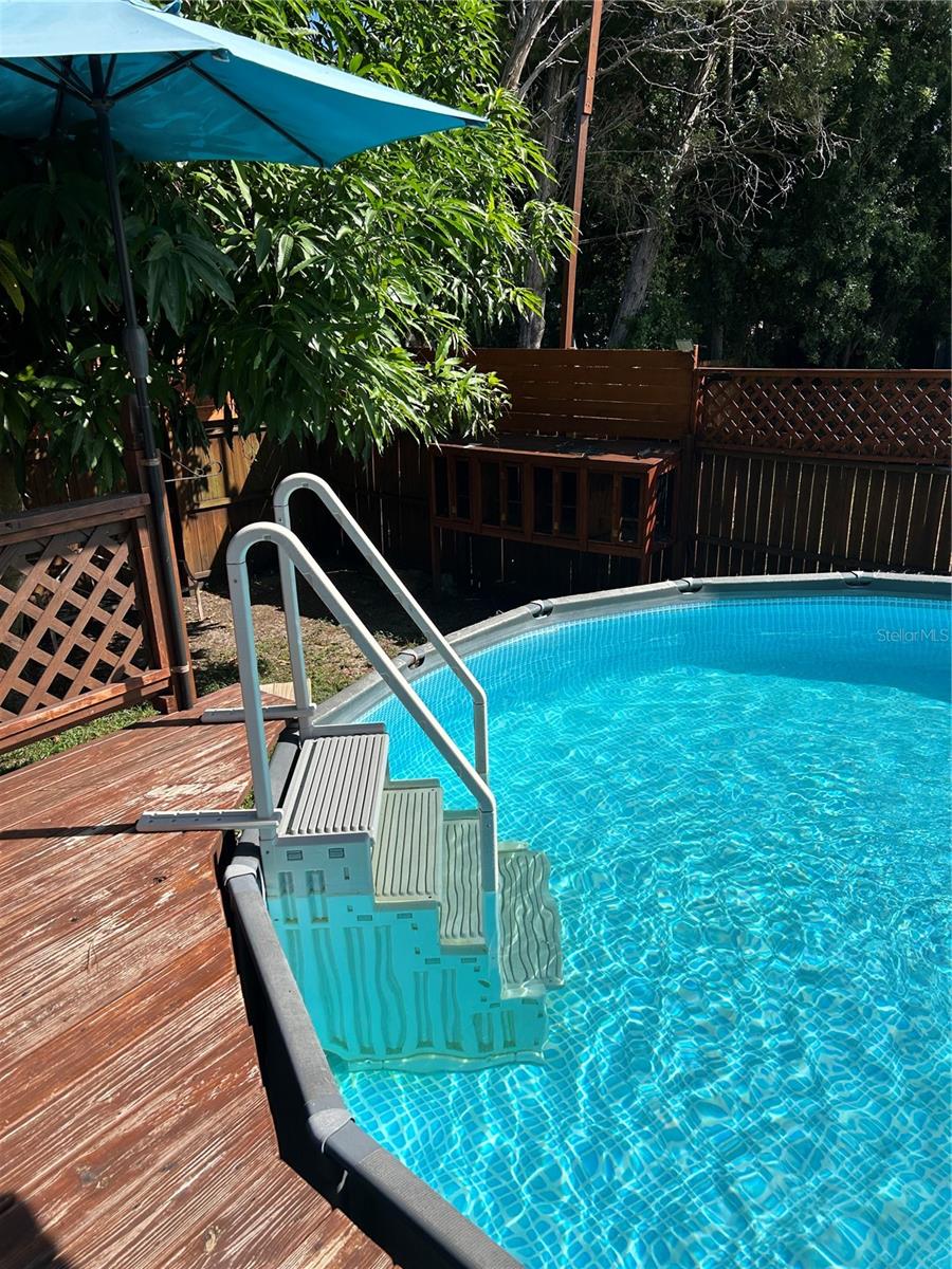Above ground pool with wrap around deck