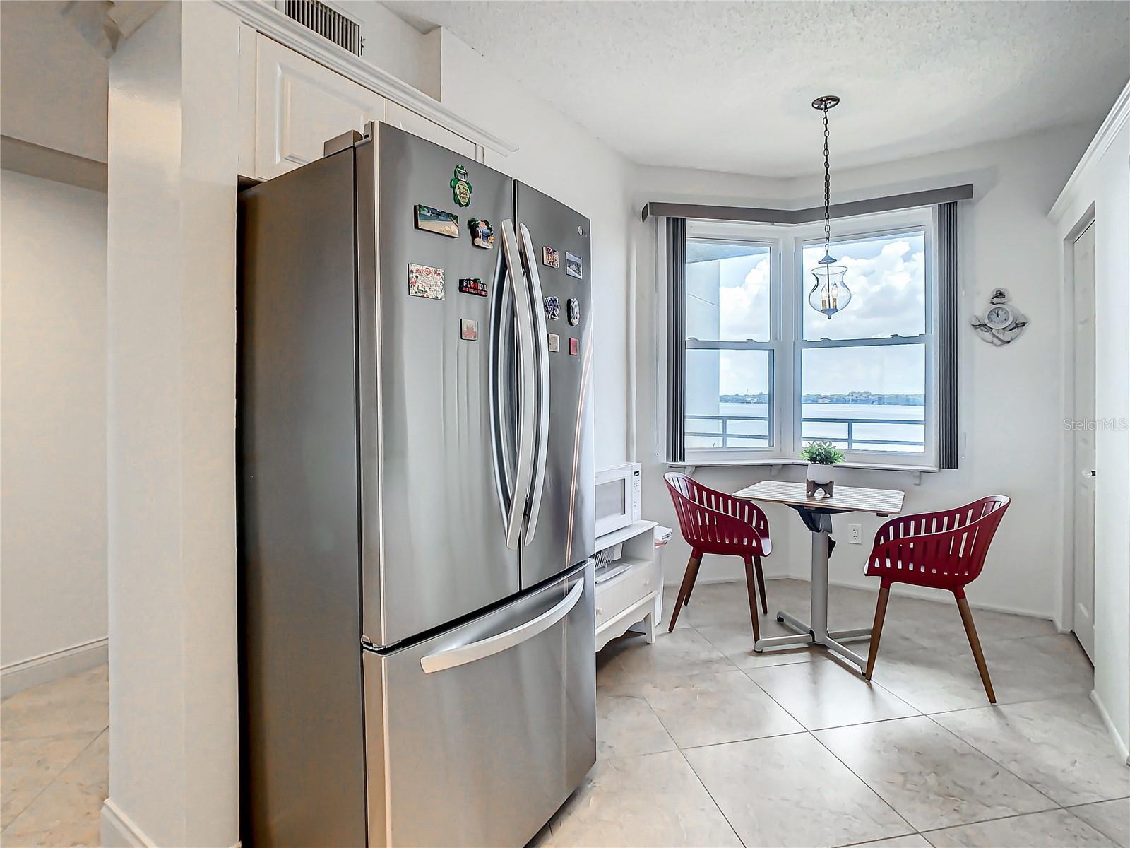This kitchen comes with a stainless steel French door refrigerator.  Notice the nice water view you can enjoy siping your morning coffee or tea