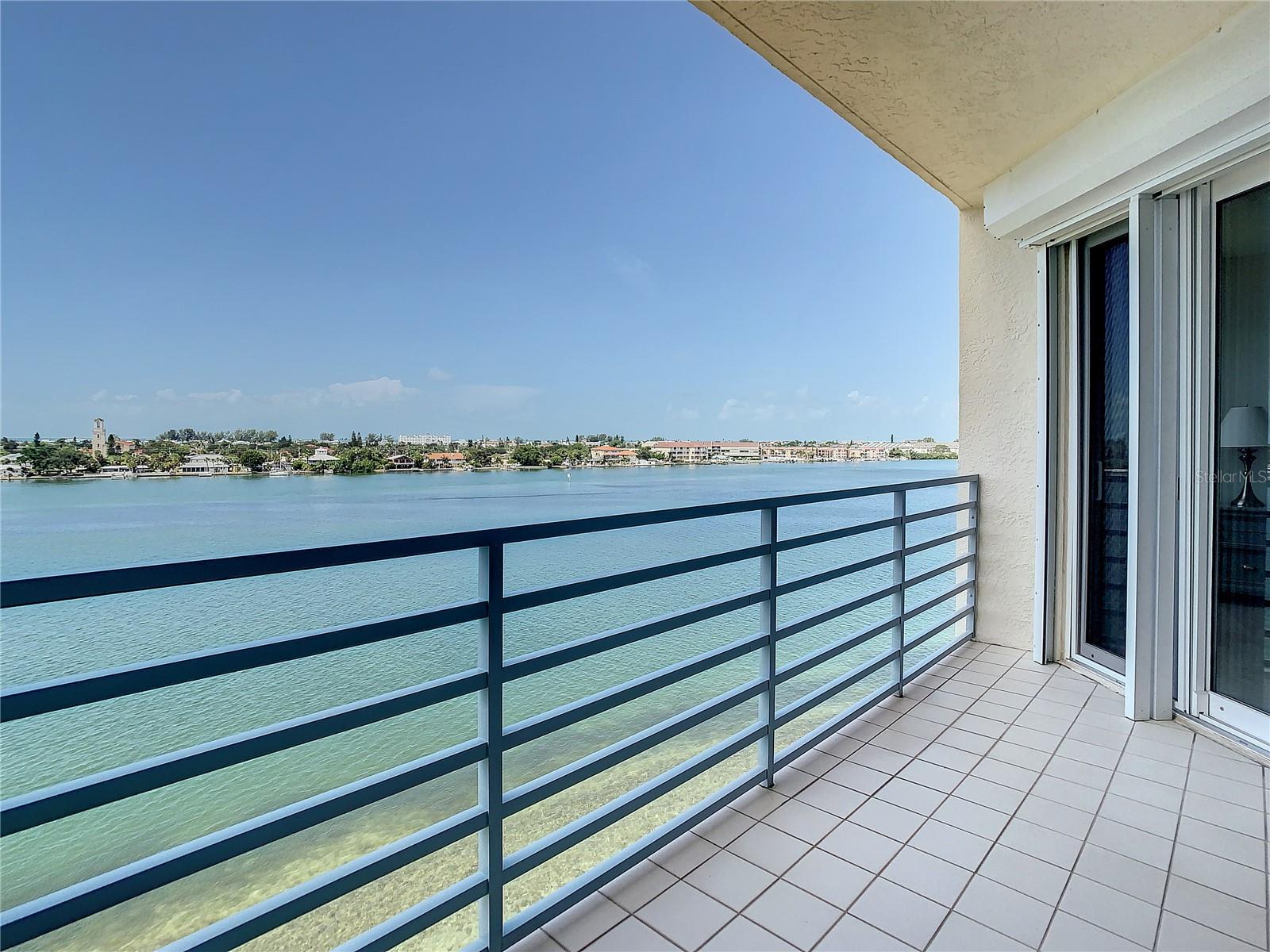This is such a nice sized balcony.  Your sliders have electric hurricane shutters.  Notice the beautiful views.