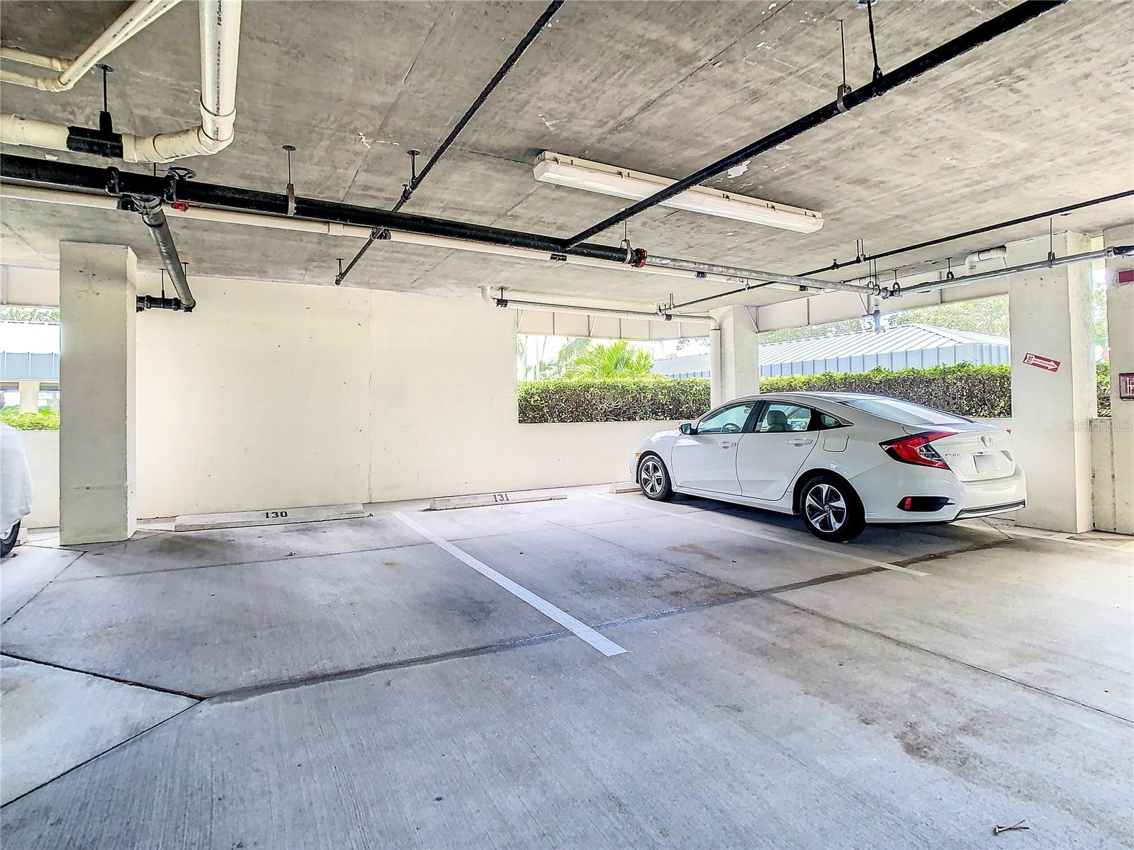 You are assigned one covered parking space with your condo.  It is nice that you don't have another car on one side of yours.  This space is located under the building.