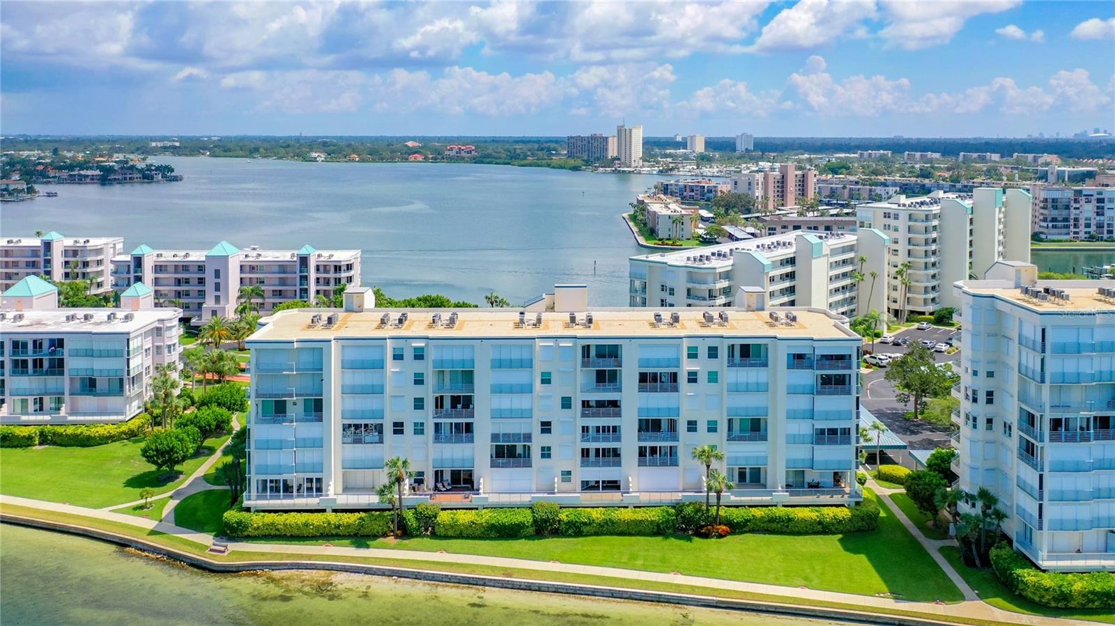 This is a closer aerial view showing the views of the back of the building and the water that you will view from the kitchen in your condo in the front