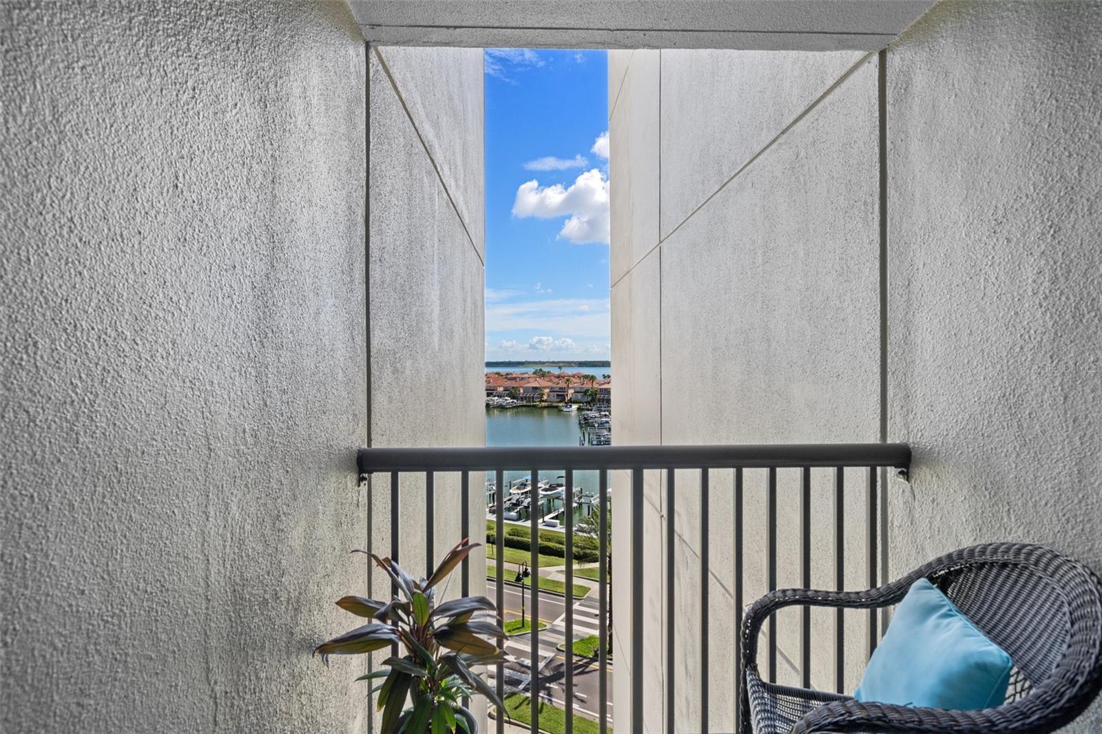 Guest room with private balcony and views of the marina and beyond.