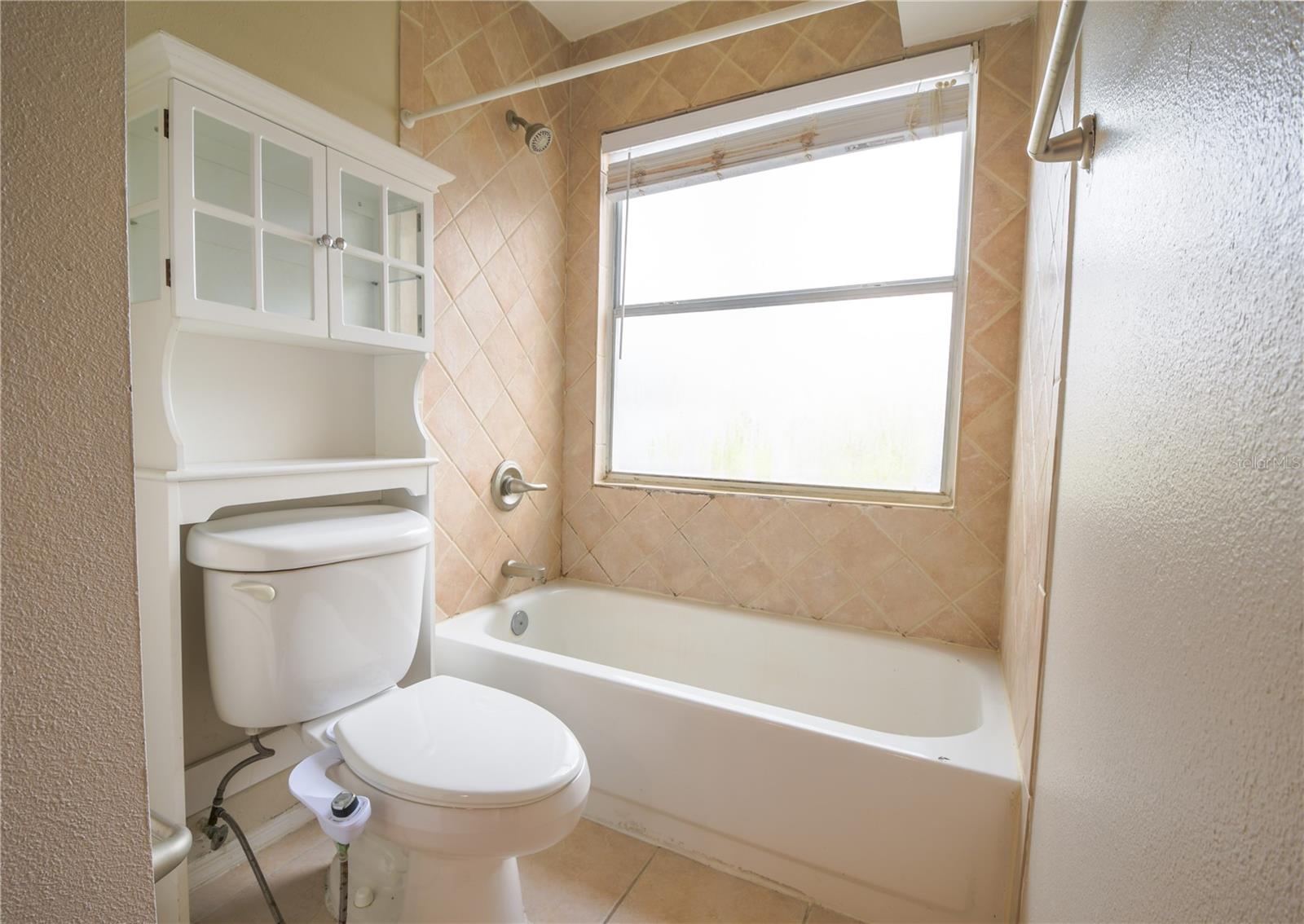 The primary bathroom features a tub with shower.
