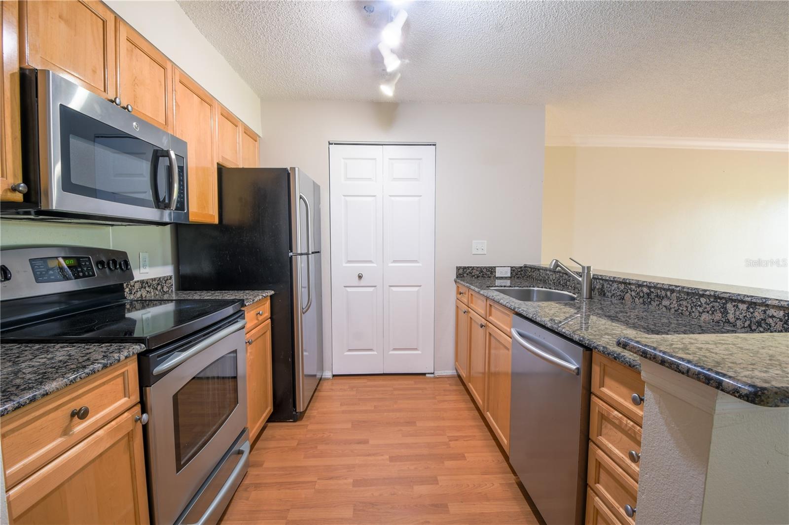 The kitchen features a suite of of stainless steel appliances.