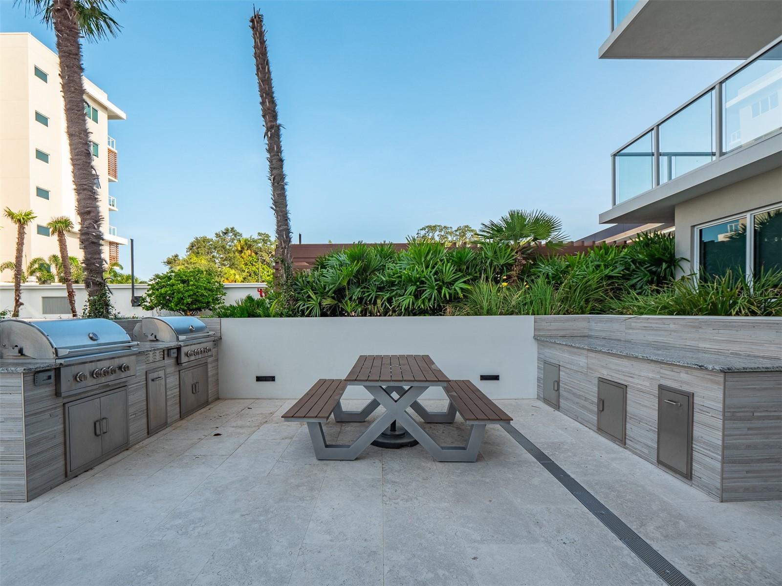 Outdoor grilling and dining area by the pool