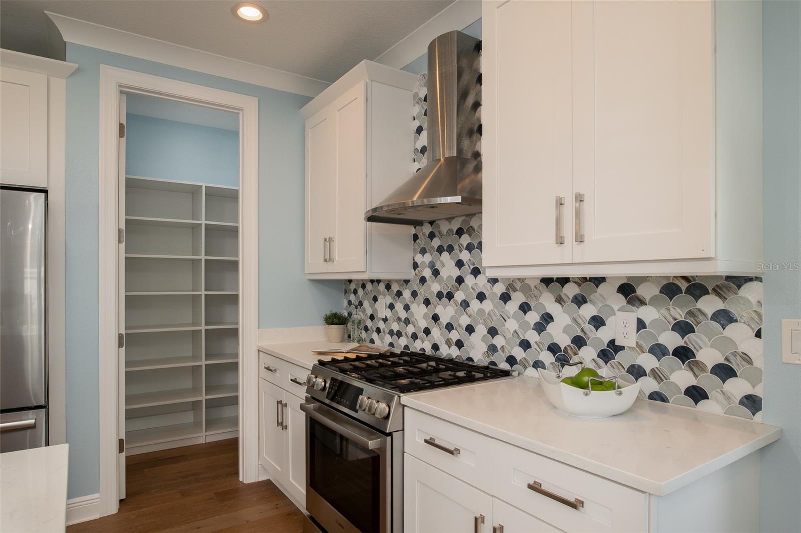 The walk-in pantry boasts custom-built shelving and storage solutions, offering both practicality and elegance, ensuring that every culinary necessity is effortlessly organized and readily accessible in your coastal retreat.